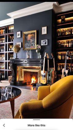 a living room filled with furniture and a fire place next to a book shelf full of books