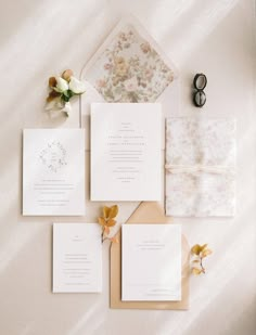 the wedding stationery is laid out on top of each other