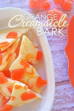 orange creamsicle bark on a plate with gummy bears