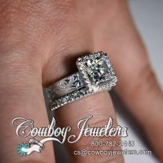 a woman's hand with a diamond ring on top of her finger and the words cowboy jewelers written below it