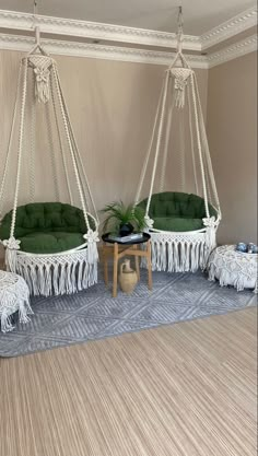 a living room with hammock chairs and rugs