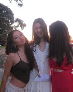 three young women standing next to each other