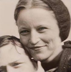 an old photo of two women hugging each other with one woman's face to the side