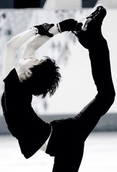 a man doing a handstand on the ice