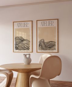 two framed pictures hang on the wall above a round table with chairs in front of it