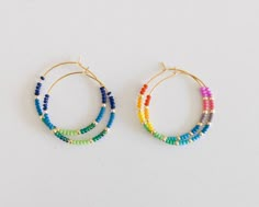 two pairs of hoop earrings with multicolored beads