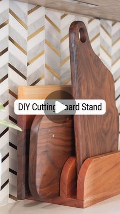 a wooden cutting board sitting on top of a counter next to a potted plant