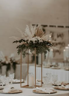 the centerpieces are surrounded by candles and greenery, along with other decorations