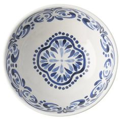 a blue and white bowl sitting on top of a table