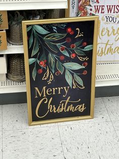 a merry christmas sign is on display in a store