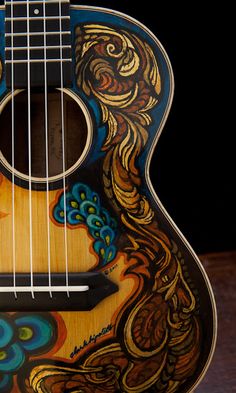 an acoustic guitar with colorful designs on it