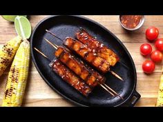 bbq chicken skewers with corn on the cob and tomatoes