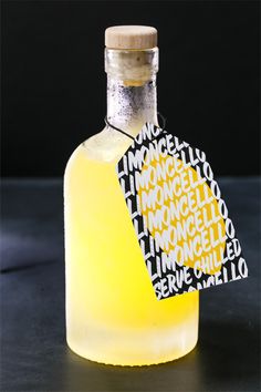 a bottle of lemonade sitting on top of a black table next to a tag