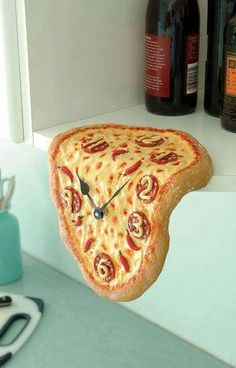 a clock made to look like a slice of pizza