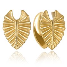 a pair of gold earrings with large leaves on the front and back of each ear