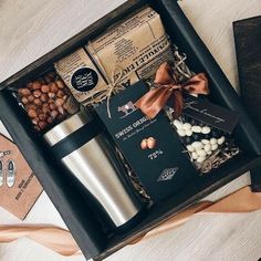 an open box containing coffee, nuts and chocolates