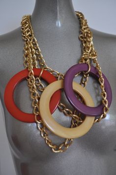 Fabulous bib necklace with huge plastic or lucite loops. Gold hardware chains and multicolor loops. Necklace closes close to the neck,strands hang down in different lengths. No damages no missing links. Not signed, statement piece. Free domestic shipping, international inquire for quote. Measures in length 18 inch, length down to the end of coins 8 inch Get 15% discount w code crazyfashion 70s Jewelry Disco, Womens 70s Fashion, 70s Accessories Jewelry, 70s Women Fashion, Chunky Jewellery, 70s Jewelry, Trending Necklaces, Metallic Purse, Long Pendant Necklace