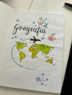 an open notebook with the words geographia written on it and a world map