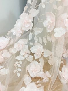 a white dress with pink flowers on it