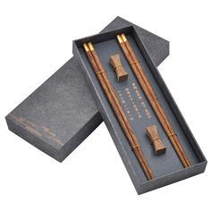 two wooden chopsticks in a gift box