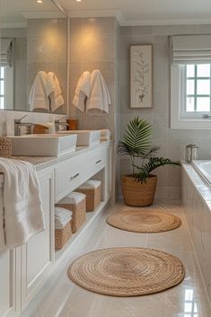 a large bathroom with two sinks and towels on the rack in front of the bathtub