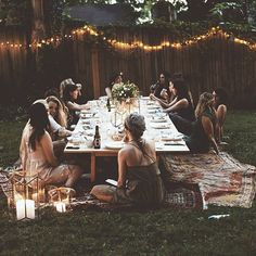 a group of women sitting around a table with plates and drinks in front of them