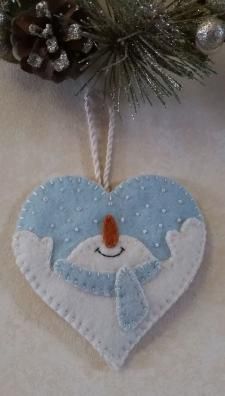 a felt ornament hanging from a christmas tree