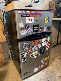 a refrigerator covered in stickers and magnets