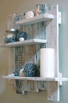 two wooden shelves with candles and other items on top of them, hanging from the wall