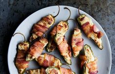 bacon wrapped jalapenos on a white plate