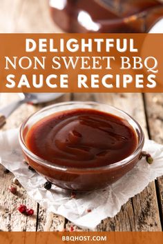 a bowl filled with bbq sauce sitting on top of a wooden table