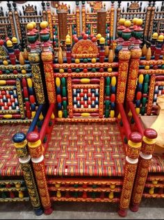 an elaborately decorated chair with red, yellow and blue accents