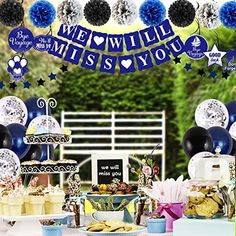 a table topped with lots of desserts and balloons