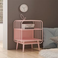 a pink shelf next to a wall with a clock on it and some books in front of it