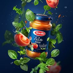 a jar of tomato sauce surrounded by basil leaves and tomatoes on a dark blue background