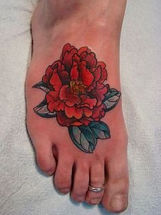 a foot with a flower tattoo on it