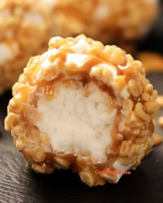 some kind of food that is sitting on a black surface with other foods in the background