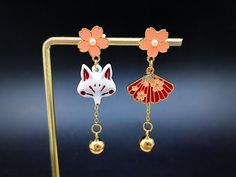 asymmetrical kitsune earrings Japanese fox mask dangling with Japanese sakura cherry blossom Japanese fox jewelry with silver stems Kitsune Earrings, Clay Diys, Japanese Fox Mask, Earrings Japanese, Japanese Fox, Japan Jewelry, Fox Jewelry, Japanese Sakura, Fox Mask