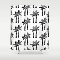 a shower curtain with black and white palm trees