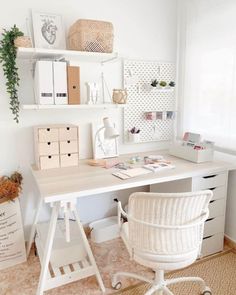 a white desk and chair in a small room with shelves on the wall above it