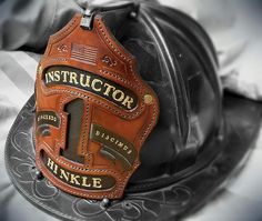 a hard hat with an instructor's name on it sitting on top of a bed