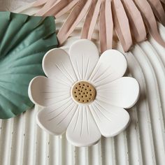 a white flower sitting on top of a table