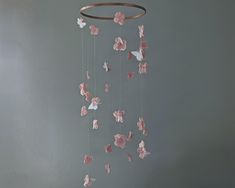 This floral mobile features muted pink hydrangea blossoms hanging in a double helix. The spiral looks lovely as it turns, and also reveals 5 dainty butterflies landing on the flowers. Your baby will love watching the mobile as it free-spins in a breeze.  Materials: -Silk flowers -Bamboo hoop -your choice of butterflies I can make this to order in other colors of blossoms or butterflies. Just shoot me a message to customize before ordering! You can also customize your mobile by choosing the hoop color that best matches your nursery. Our most popular hoop color is metallic gold, but the white option looks lovely with this style as well. For a more rustic look, the hoop can be wrapped in burlap or twine.  The last photos show different butterfly types. The mobile pictured has felt butterflies Flower Mobile Nursery, Spinning Babies, White Nursery Decor, Butterfly Cutout, Pink Crib, Butterfly Mobile, Flower Mobile, Silk Florals, Silk Hydrangeas