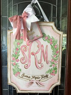 a sign that says srm hanging on the side of a door