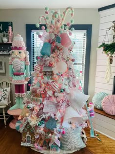 a pink christmas tree decorated with candy and candies