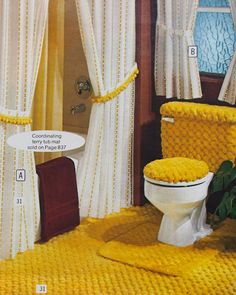 a bathroom with yellow rugs and curtains on the shower curtain, toilet seat cover and sink