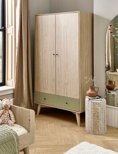 a wooden cabinet sitting next to a window in a bedroom