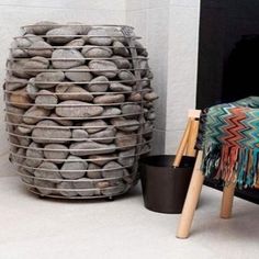 there is a basket made out of rocks next to a fire place