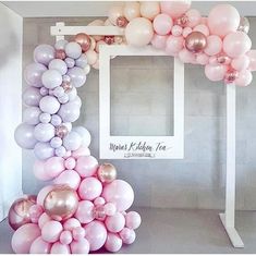 the balloon arch is decorated with pink, white and gold balloons