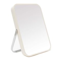 a white mirror sitting on top of a table